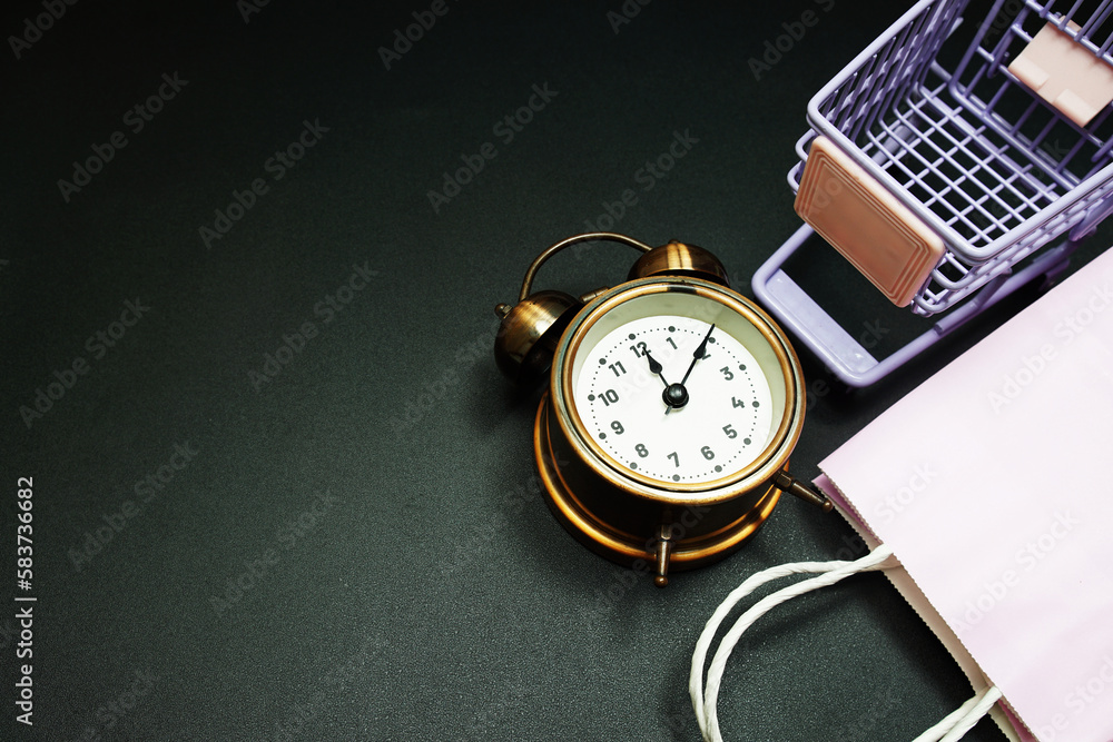 Poster trolley cart and shopping bag with alram clock with space copy on black background
