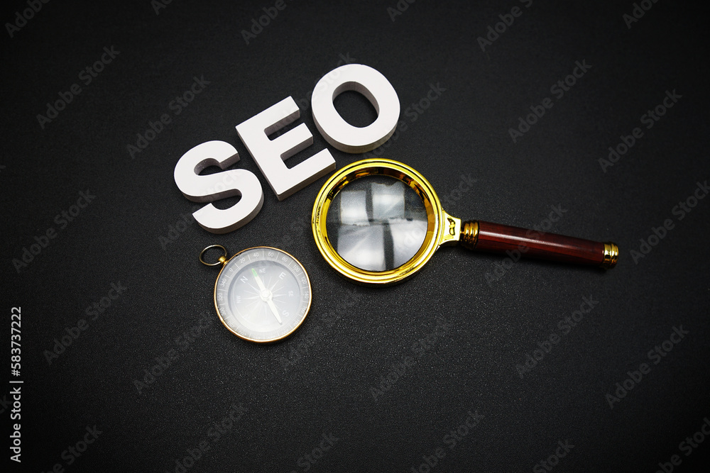 Poster seo (search engine optimization) text message with magnifying glass on black background