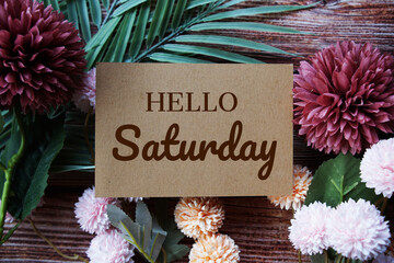 Happy Saturday text message with flower decoration on wooden background © may1985