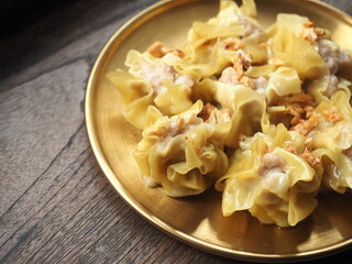 Chinese steamed dumplings in golden plate