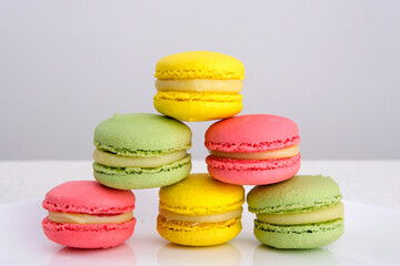 Fototapeta na wymiar Sweet and colourful french macaroons on white background, Dessert. High quality photo