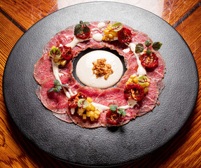Delicious veal carpaccio with Parmesan cheese