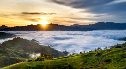 Panoramic view of sunrise with a trail going through a valley filled with white clouds in the Tak Po mountains in Tra Tap commune, Nam Tra My district, Quang Nam province, Vietnam