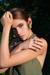 Obraz premium Girl beauty face on palm leaves. Summer portrait of beautiful young woman. Beauty summer female portrait. Sexy woman enjoying summer vacation.