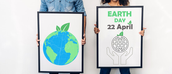 Couple posing and showing white blank board with saving clean energy earth globe world environment green eco friendly.campaign save the earth and earth Day 22 April