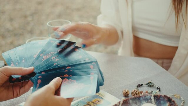 Bald fortune teller reading tarot cards, doing a reading for a client