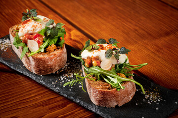 Italian bruschetta with roasted tomatoes, mozzarella cheese and herbs