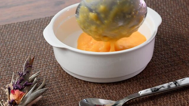 Serve creamy corn potage soup on a plate