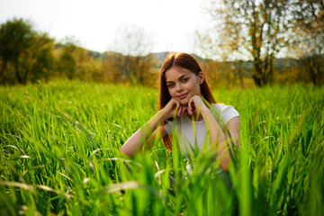 Beautiful healthy Young Woman relaxing on the green grass