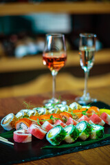 Sushi roll with salmon and avocado with glass of wine..