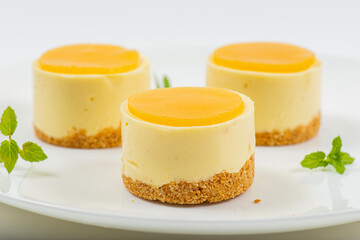 Creamy petite mango cheesecake with mango jelly and a wholewheat biscuit crumb base.