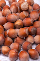 Close up photo of raw nuts on white wooden vintage background