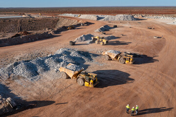Fototapeta Aerial view of mining trucks at a mine site in Australia obraz