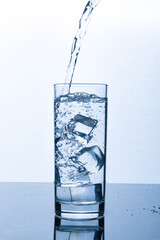 drinking water pouring into glass with ice