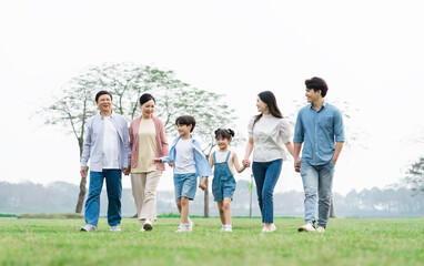 Asian family photo walking together in the park