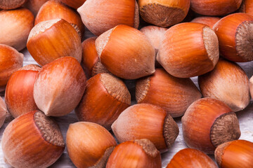 Close up photo of raw nuts on white wooden vintage background