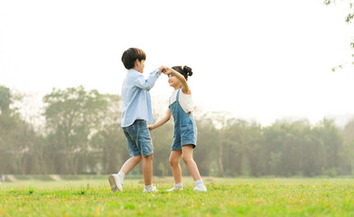 Obraz premium image of brother and sister having fun in the park