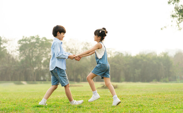 image of brother and sister having fun in the park