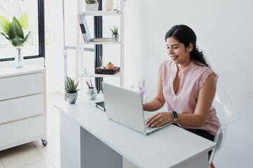 hispanic business woman working in her desk at office in Mexico Latin America	