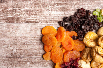Dried fruits on wooden background in close up photo