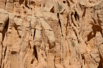 Beautiful rocks and canyons in the wild nature and the dry desert of Wadi Ghweir in Jordan on a bright sunny day