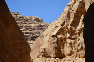 Fototapeta premium Beautiful rocks and canyons in the wild nature and the dry desert of Wadi Ghweir in Jordan on a bright sunny day