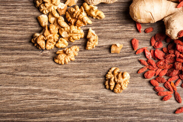 Different type of nuts on wooden background in studio photo