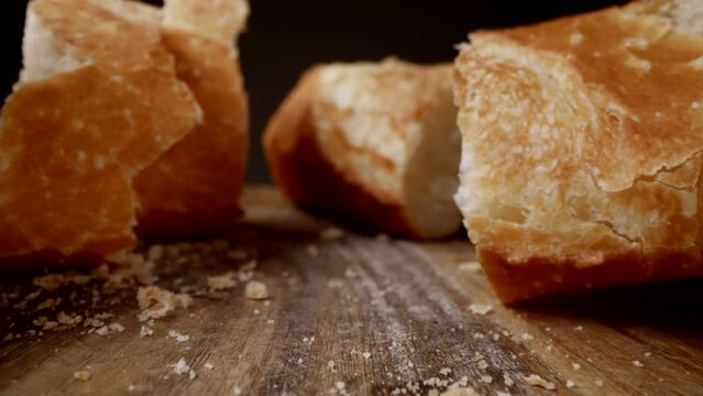 macro shot with cut fresh bread on wooden cutting board, moving closeup view in bakery