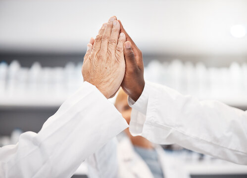 High five hands, scientist and group in lab for results, success or congratulations for pharma. Science teamwork, team building and motivation for research, medical innovation or pharmaceutical study