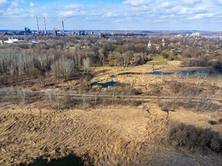 Aerial view landscape. Factory chimneys, ponds, dry grass, industry.