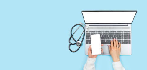 Female doctor's hands holding smartphone with blank transparent screen and using laptop with empty transparent monitor on blue background. Top view with copy space. Telemedicine concept