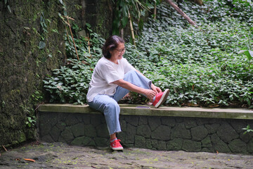 Woman sitting and taking a break after walking around the park