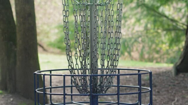 Disc Landing in Frisbee Golf Basket Slow Motion