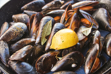 pan full of steamed mussels as served in a restaurant at Cangas