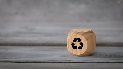Business  design concept. Abstract geometric wooden dice isolate with a recycle symbol on white rustic surface.