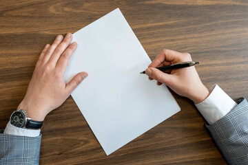Close up business man reaching out sheet with contract agreement proposing to sign.Full and...