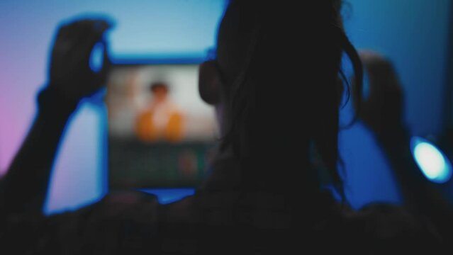 Young man in glasses working on video editing on computer doing montage and color correction. Professional man hand making edits on a special panel. Concept of creating video content.