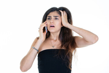 brunette surprised woman hearing bad news on the phone with hand in hair talking on cell smartphone on white background