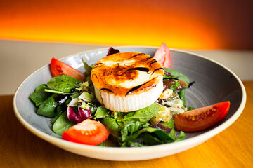Delicious and healthy green salad with gratin goat cheese.
