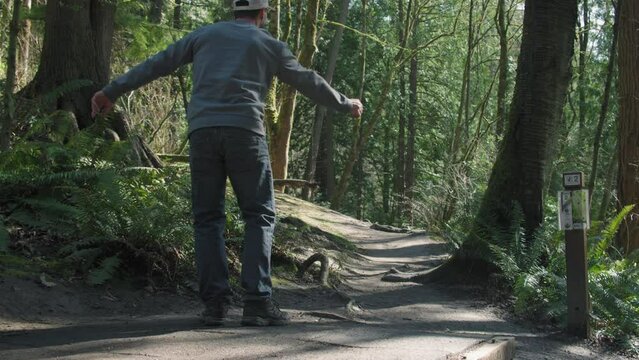 Man Tees Off Long Drive Throwing Disc on Forest Golf Course