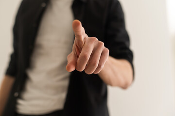 Businessman pressing an imaginary button on bokeh.