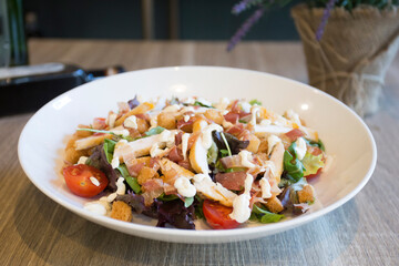A Caesar salad is a salad of romaine lettuce, croutons, and chicken with lemon juice, olive oil, egg, Worcestershire sauce, anchovies, garlic, Dijon mustard, Parmesan cheese, and black pepper.