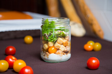 A Caesar salad is a salad of romaine lettuce, croutons, and chicken with lemon juice, olive oil, egg, Worcestershire sauce, anchovies, garlic, Dijon mustard, Parmesan cheese, and black pepper.