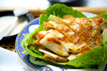 A Caesar salad is a salad of romaine lettuce, croutons, and chicken with lemon juice, olive oil, egg, Worcestershire sauce, anchovies, garlic, Dijon mustard, Parmesan cheese, and black pepper.