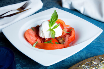 Burrata salad. The burrata is a fresh cow's milk cheese, with spun paste and round in shape, with...