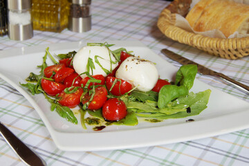Burrata salad. The burrata is a fresh cow's milk cheese, with spun paste and round in shape, with an external appearance similar to that of mozzarella 
