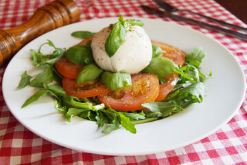 Burrata salad. The burrata is a fresh cow's milk cheese, with spun paste and round in shape, with...