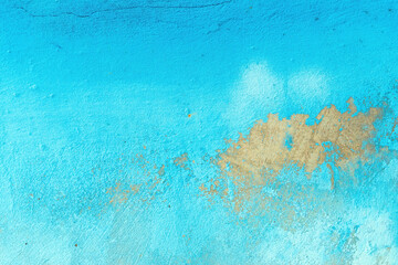 Blue paint peeling off the old concrete wall of a worn house as background