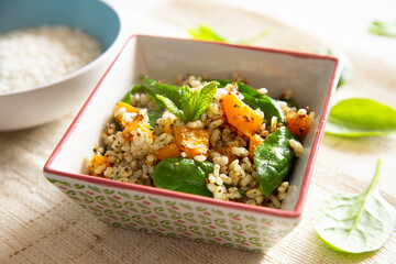 Delicious rice salad with pumpkin and spinach