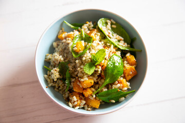 Delicious rice salad with pumpkin and spinach